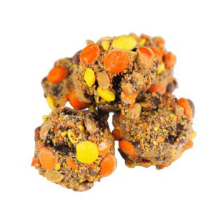 Indulge your sweet tooth with our irresistible Reese's Pieces Cake Balls. We start with a rich Devil's Food cake, blend it with creamy chocolate frosting, and fold in mini Reese's Pieces for a delightful crunch. Each cake ball is then dipped in a luxurious dark chocolate coating, creating a truly decadent treat. Order your Reese's Pieces Cake Balls online today and experience the perfect combination of chocolate and peanut butter!